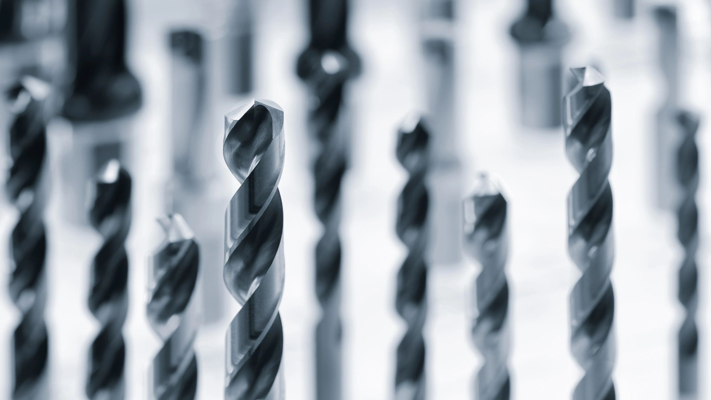 A row of metal drills and milling cutters.